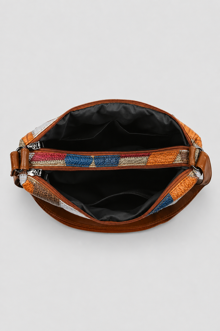 Detail view of an elegant women's patchwork shoulder bag, showcasing intricate artistic design and unique patterns.
