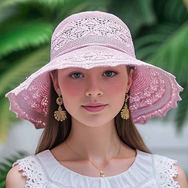 Elegant women's patterned sun hat with wide brim for stylish sun protection on the beach or travel.