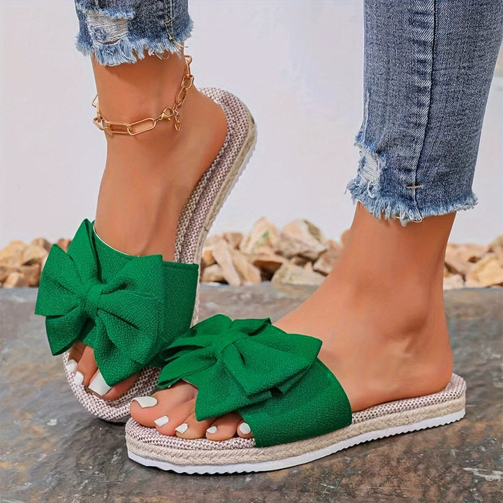 Chic open-toe pearl slide sandals for women, offering effortless summer style and comfortable flat design.