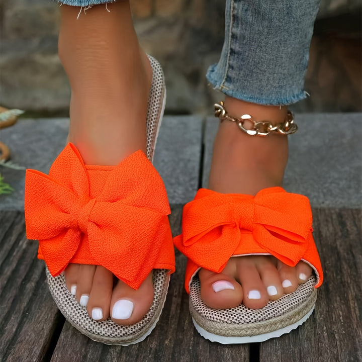 Women's elegant pearl slide sandals, essential summer footwear for a chic and comfortable vacation look.