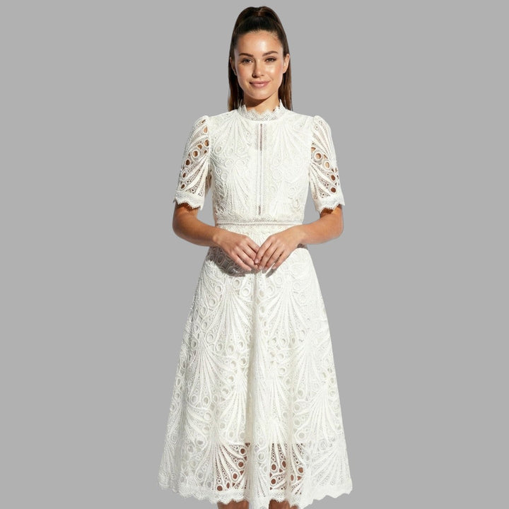 Sophisticated white lace midi dress for women. High neck, short sleeves. Ideal for elegant special occasion events.