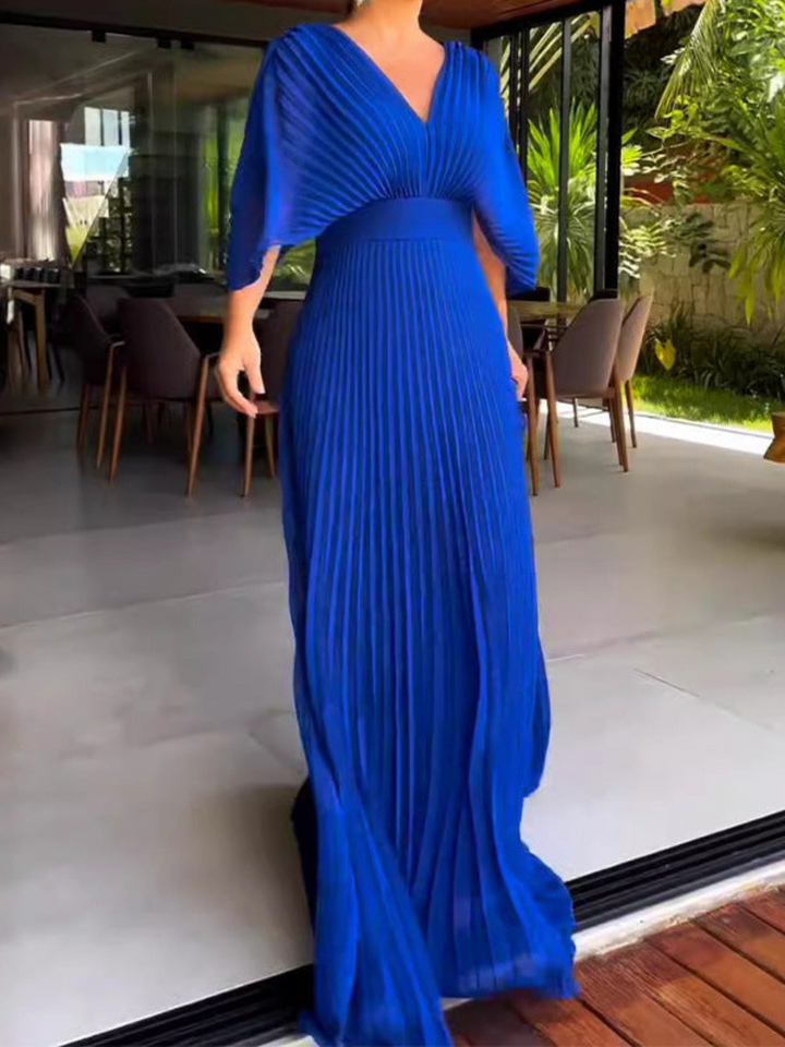 Stunning formal evening gown for women; a pleated maxi dress with sophisticated batwing sleeves.