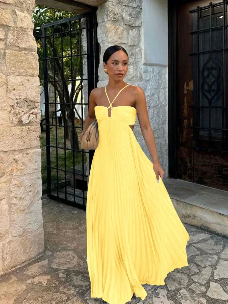 Flowy sleeveless pleated halter maxi dress for women, with elegant design suitable for special occasions.
