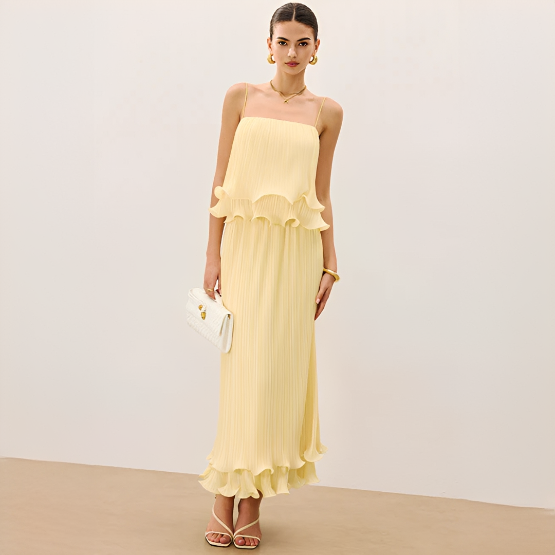 Women's chic pleated maxi skirt and square neck top co-ord set with ruffles. Elegant two-piece summer occasion wear.