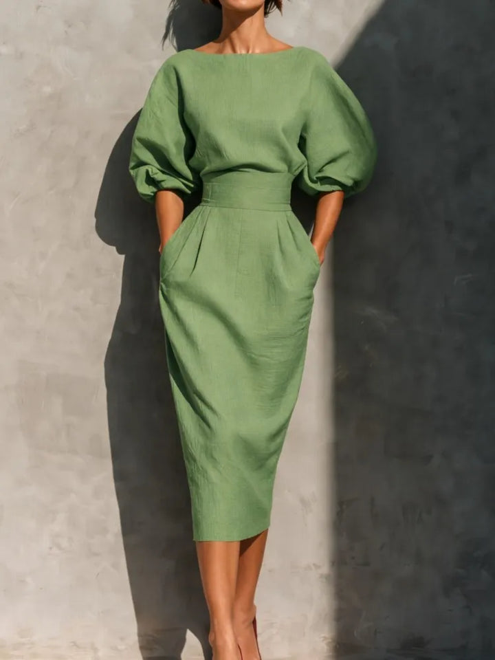Office-ready women's elegant pleated midi dress with stylish lantern sleeves & cinched waist, classic style.