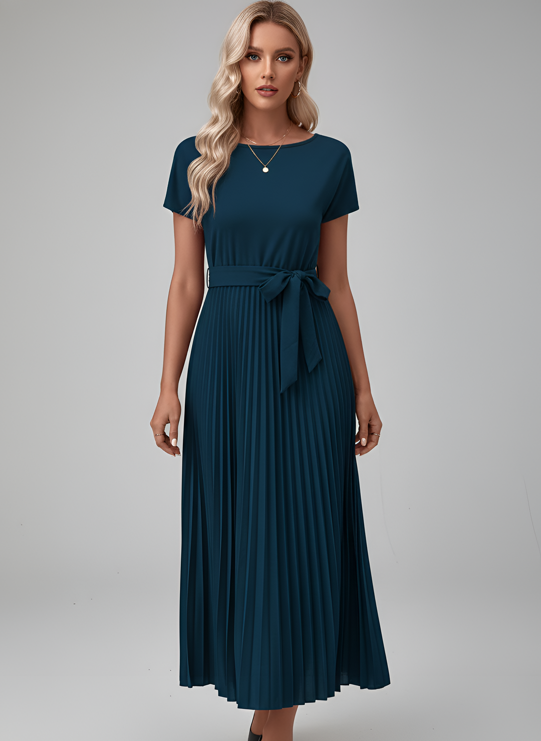 Stylish women's chic pleated midi dress. Short sleeves and a cinched belt offer a sophisticated look.
