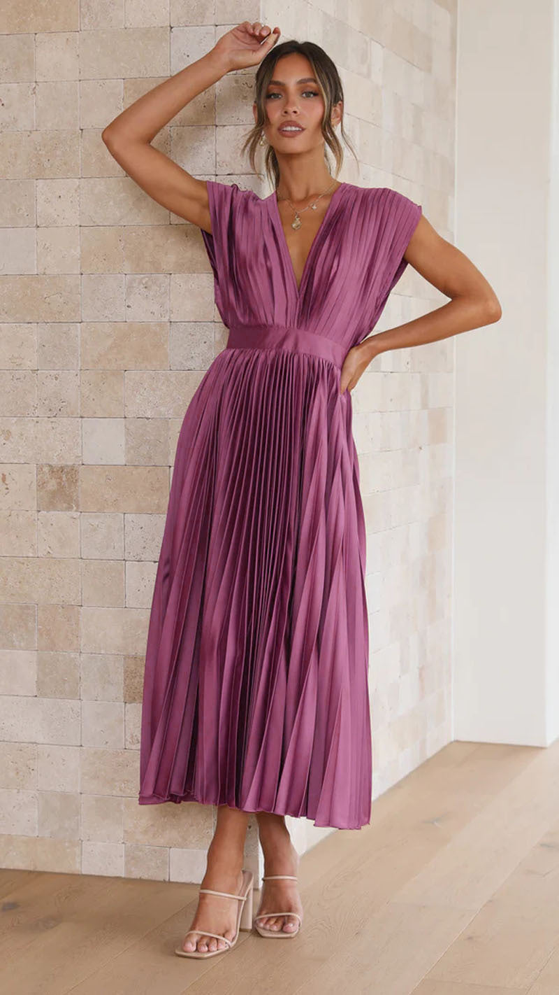 Flowy pleated V-neck midi dress for women. Offers a flattering silhouette and relaxed elegant style for summer.