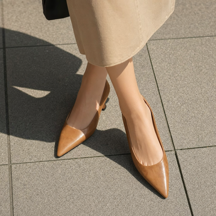 Classic women's slip-on pumps featuring a stylish pointed toe & slender heel for evening attire.