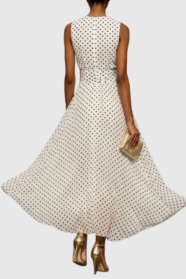 Chic A-line polka dot maxi dress, sleeveless halter neck style, ideal for vacation wear or casual elegance.