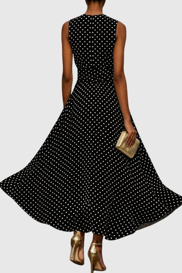 Formal women's elegant polka dot maxi dress with a flattering silhouette and beautiful ruffle hem detail. Occasion wear.