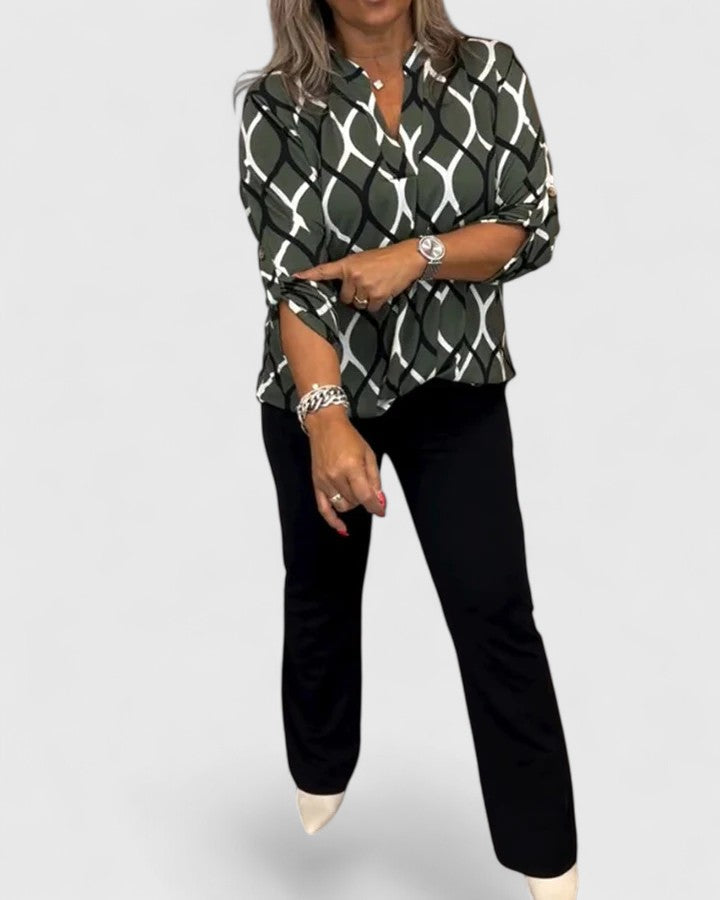 Fashionable women's printed blouse, featuring a flattering three-quarter sleeve design for modern style.