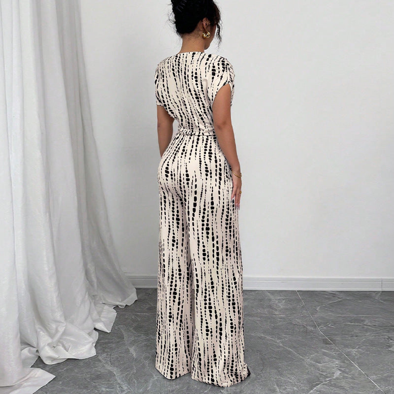 Chic women's abstract print one-shoulder wide leg jumpsuit with belted detail, ideal for summer or spring fashion.