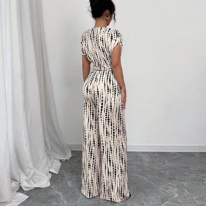 Chic women's abstract print one-shoulder wide leg jumpsuit with belted detail, ideal for summer or spring fashion.