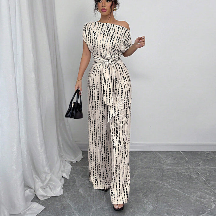 Stylish women's one-shoulder wide leg belted jumpsuit featuring a vibrant print, great for formal or evening events.