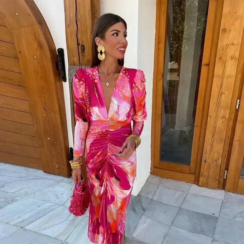 Stylish long sleeve V-neck midi dress for women, featuring an elegant print & ruched details for wedding guests.