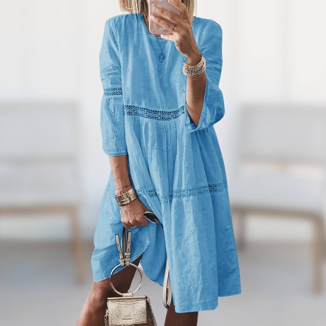 Chic white women's flowy summer dress with a round neck, comfortable and elegant for any casual or vacation outing.