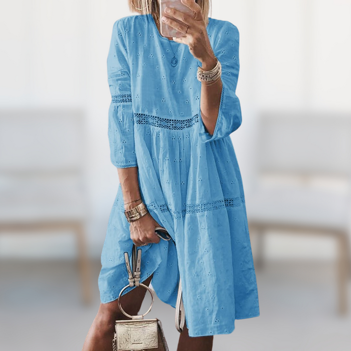 Chic white women's flowy summer dress with a round neck, comfortable and elegant for any casual or vacation outing.