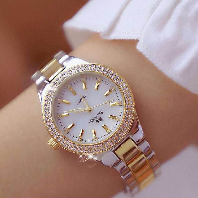 Elegant women's quartz watch. Glossy stainless steel band, round dial. A modern fashion wristwatch accessory.