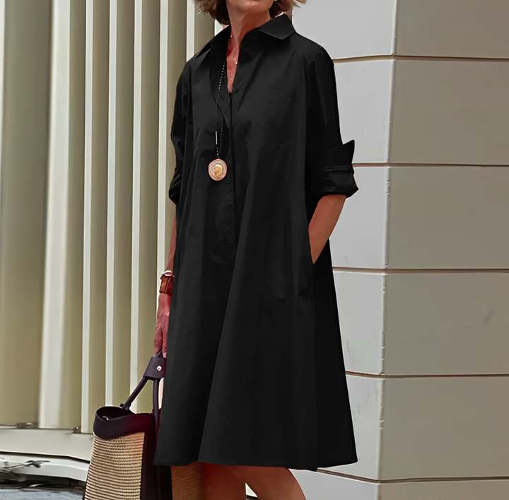 Black women's elegant button-front mini shirt dress with a relaxed fit, ideal for versatile everyday style.