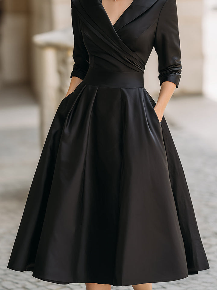 Sophisticated women's cocktail dress featuring a draped collar and midi length for special events.