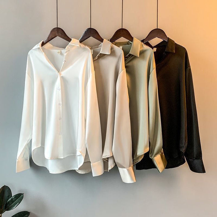 Close-up of a feminine button-up ruffle blouse, highlighting delicate ruffles and the soft fabric texture. Elegant style.