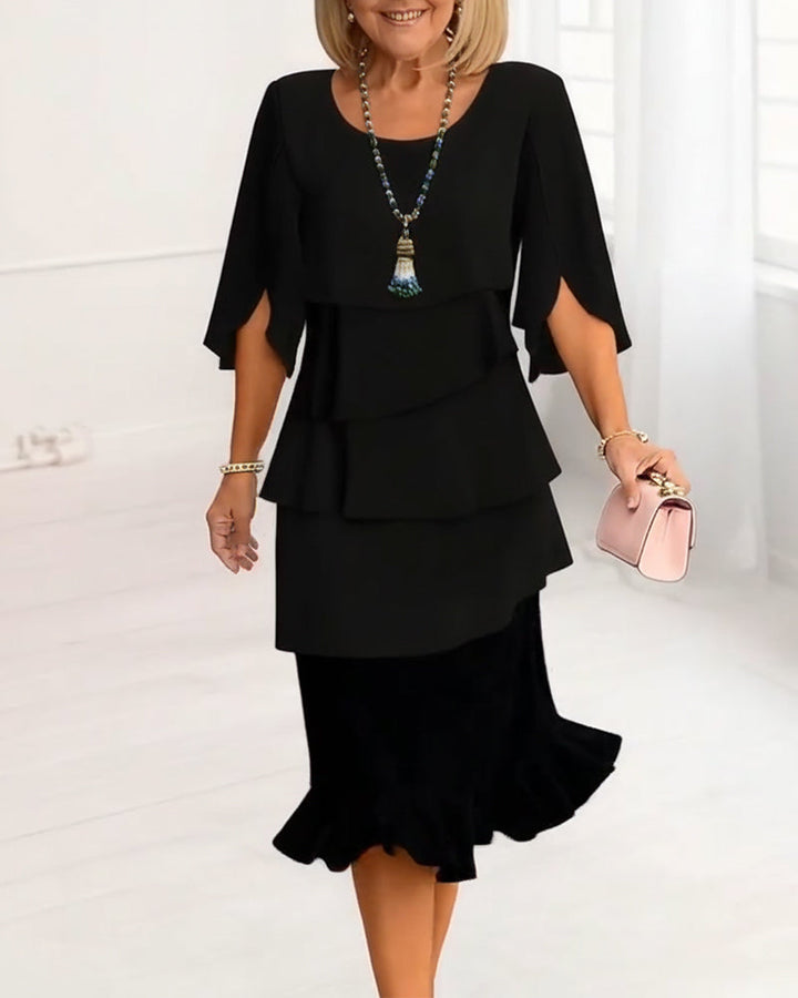 Elegant women's ruffle tiered midi dress in flowing black fabric, perfect for spring & summer occasions.