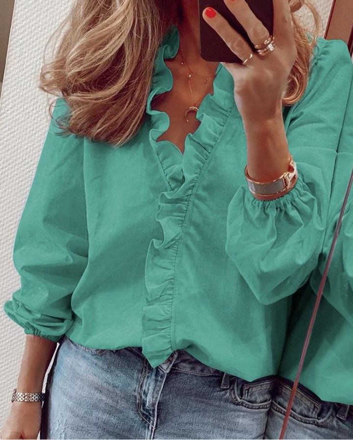 Fashionable women's ruffled V-neck blouse, an elegant and stylish top for modern office wear or casual fashion.
