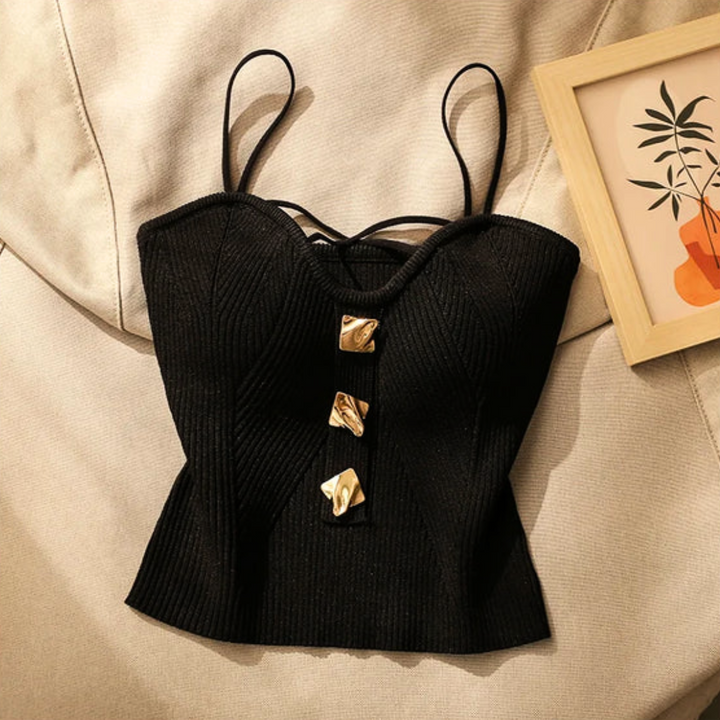 White women's sculpted corset top, figure-flattering with adjustable straps & stylish gold hardware.