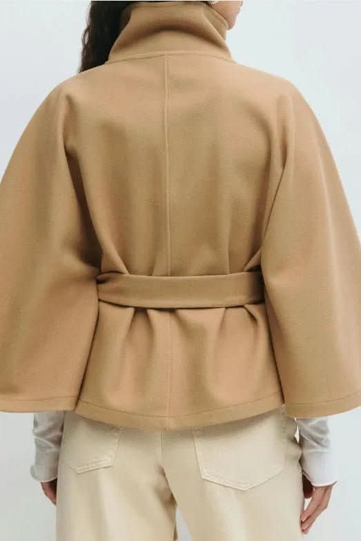 Warm women's oversized self-tie cape, elegantly draped, ideal for fall fashion and winter warmth.