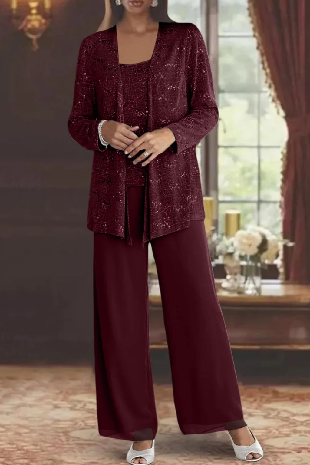 Luxurious women's sequin three-piece pant set on hanger. Features wide-leg pants, top, and elegant cardigan.