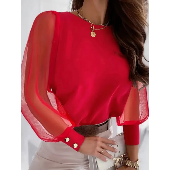 Fashionable women's top with elegant sheer sleeves and unique appliqué details for a casual chic or party look.