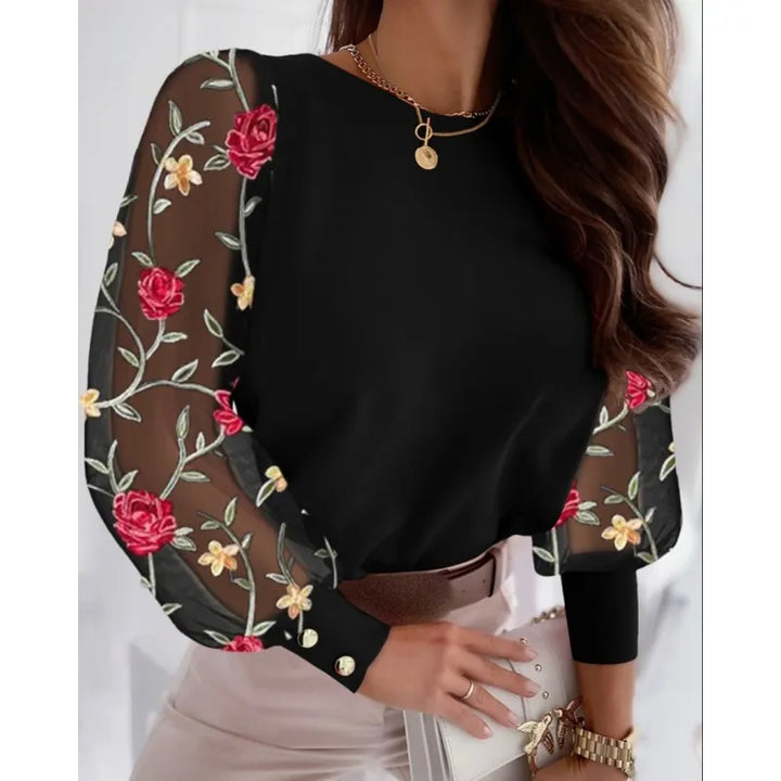 Women's long sleeve blouse with sheer fabric and beautiful appliqués, a versatile and stylish top for any occasion.
