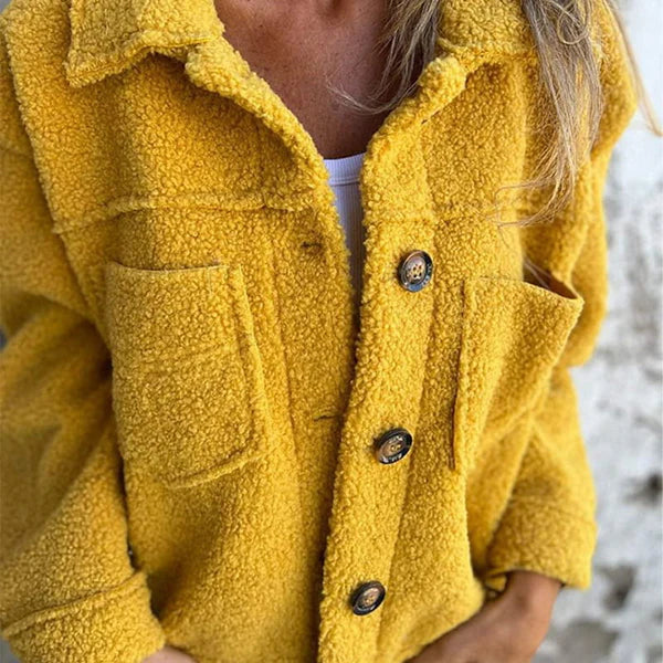Fashionable women's short jacket featuring an elegant lapel collar. Versatile outerwear for stylish fall & winter outfits.