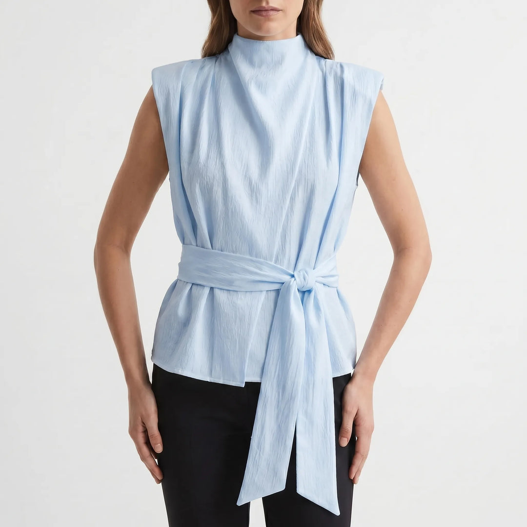 Fashionable sleeveless tie-waist top for women, featuring a sophisticated draped neckline. Great for summer events.