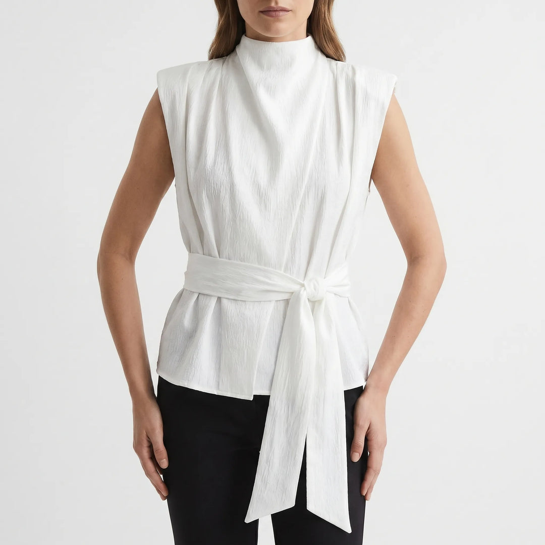 Versatile sleeveless top for women, showcasing a draped neckline and tie-waist detail. Perfect for any elegant occasion.