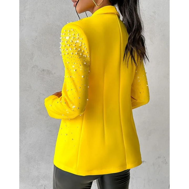 Fashionable women's slim blazer featuring elegant pearl details, ideal for a sophisticated business or party look.
