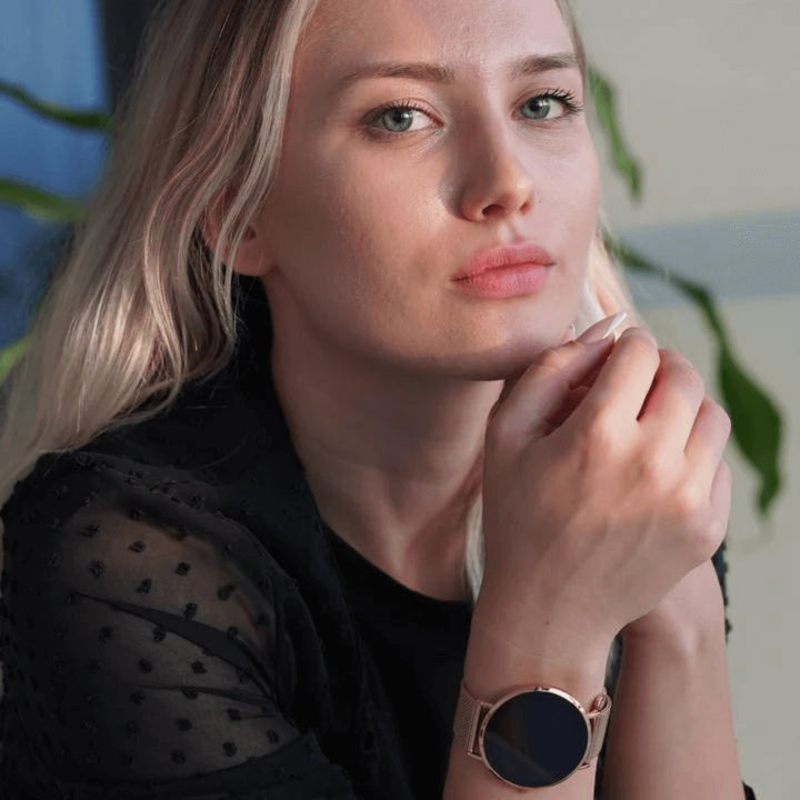 Slim women's smartwatch displaying smart notifications on a vibrant touchscreen, elegant fashion tech.