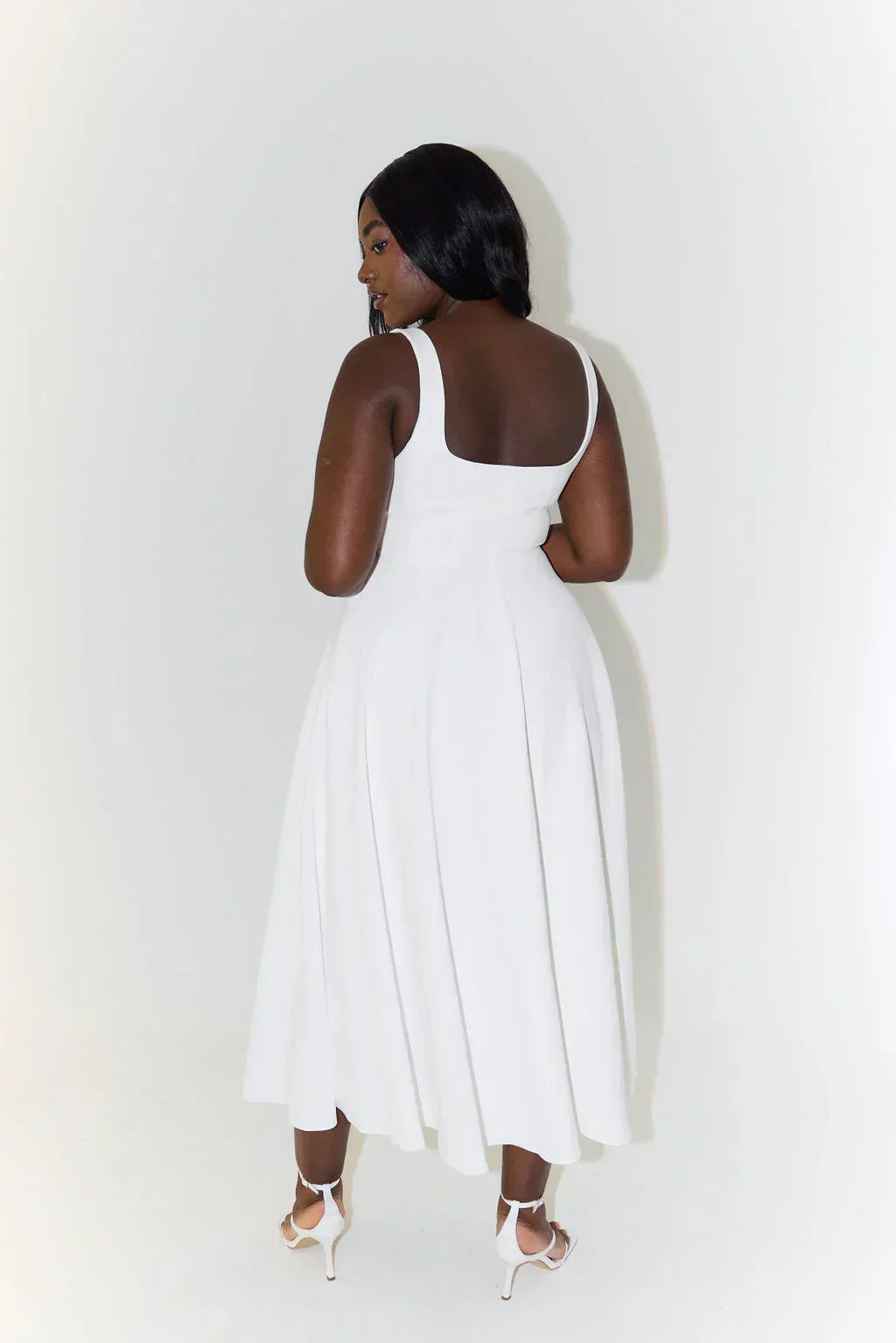 Woman in motion, wearing a comfortable and flattering square neck midi dress, perfect for all-day wear.