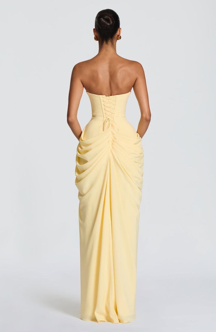 Fashionable women's strapless formal dress, a corset-style maxi gown with a daring high slit for parties.