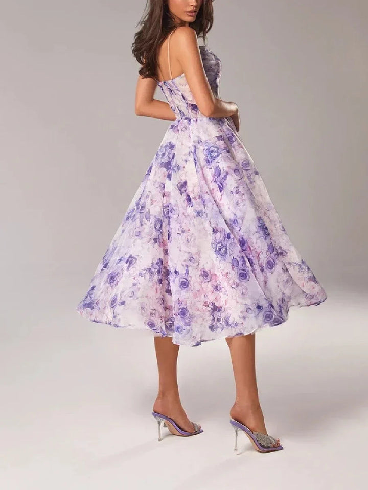 Close-up of the delicate floral print on a women's elegant strapless cocktail dress. Structured design.