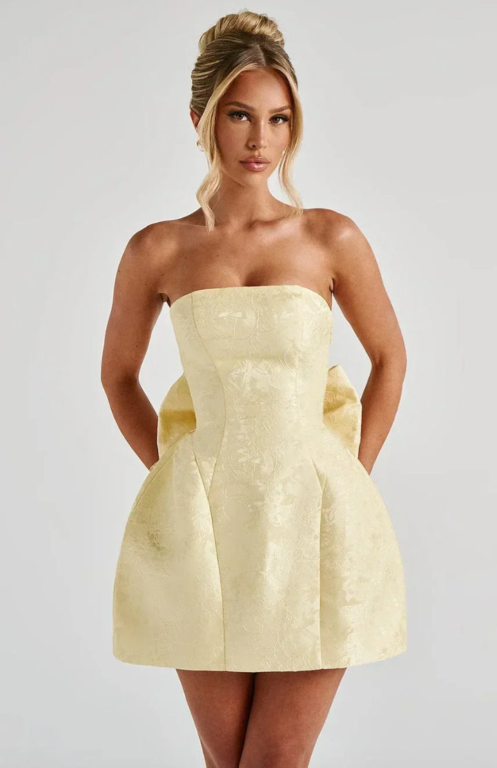 Elegant women's strapless mini dress with a charming bow back detail, perfect for special occasions.
