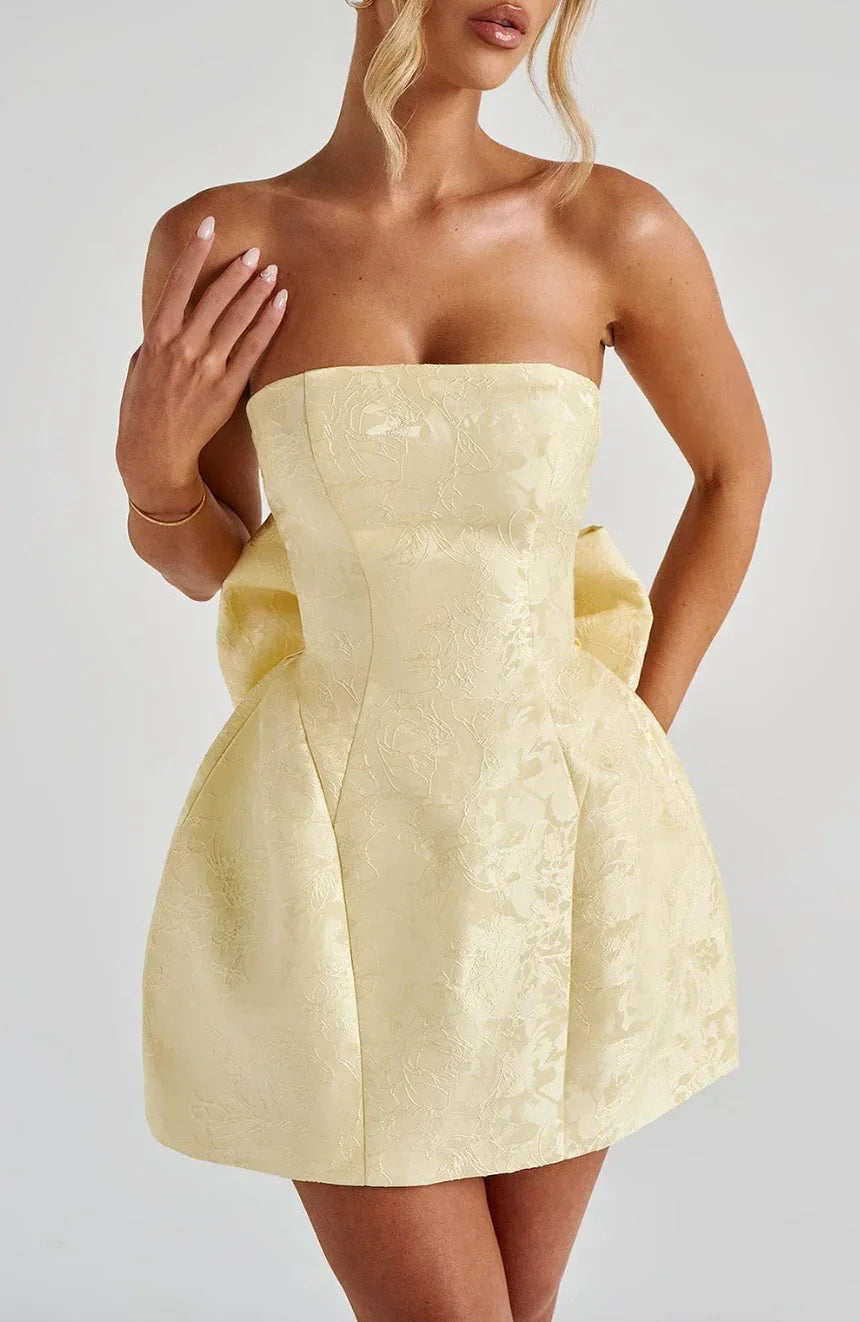 Chic pink strapless mini dress for women, with an elegant bow detail at the back, great for events.