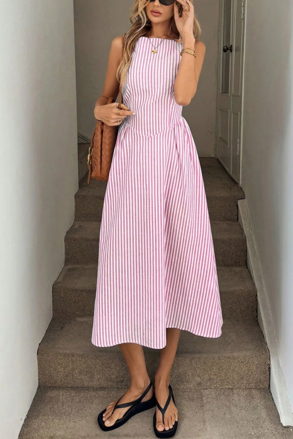 Lightweight women's striped pleated halter neck midi dress, perfect for a breezy summer day or beach vacation.