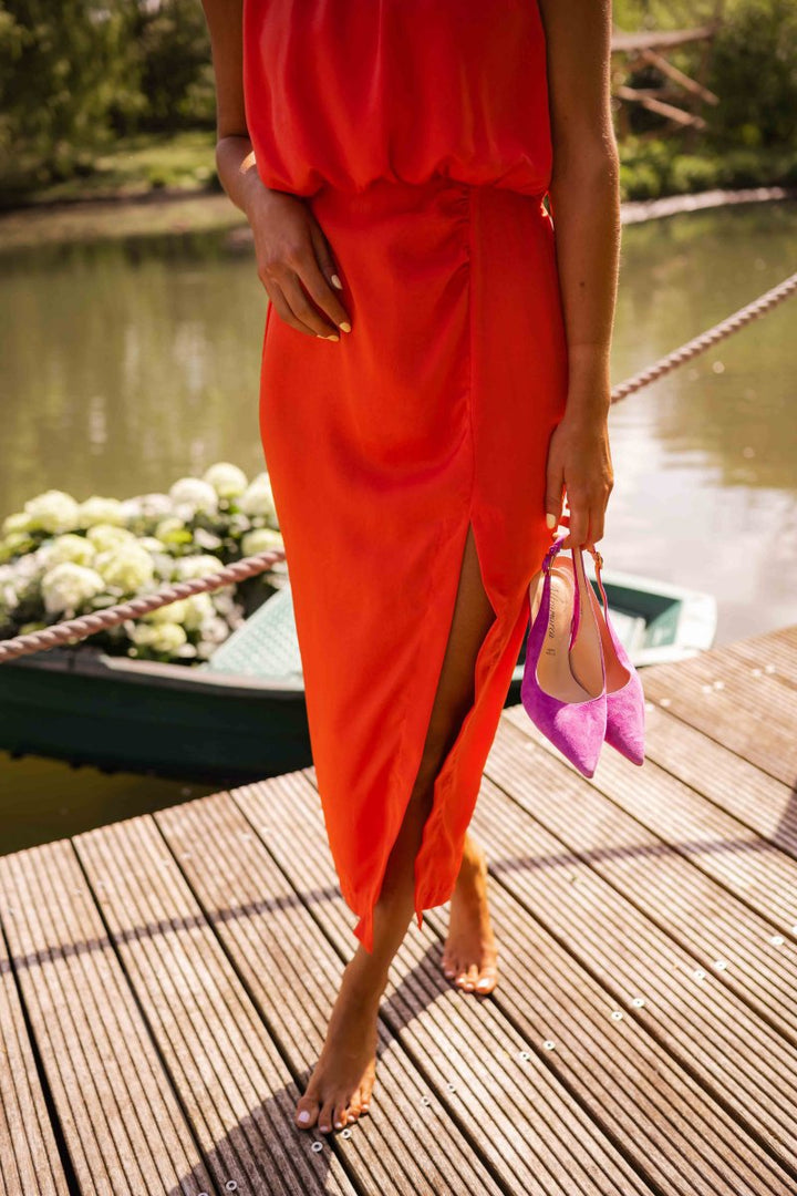 Back view of a women's elegant summer midi dress, showcasing its flowing design and adjustable straps.