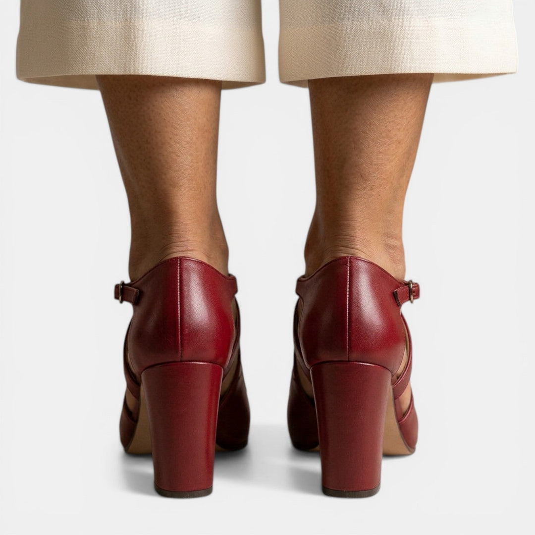 Side view of stylish women's T-strap high heel sandals, showcasing the heel and delicate straps.