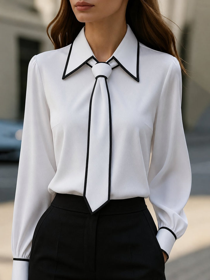 Elegant women's tie-neck blouse with contrast trim and button-down front, perfect for office or smart casual wear.