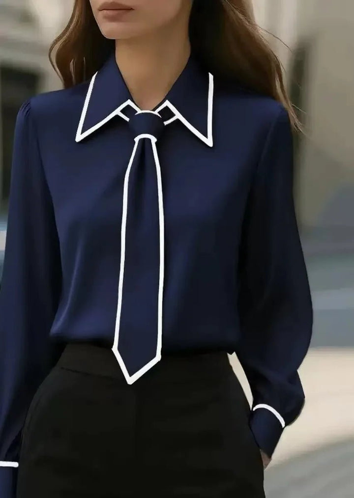 Stylish women's long sleeve tie-neck blouse in a button-down design with contrast trim, offering a refined look.