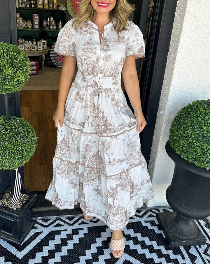 Feminine toile print maxi dress featuring a comfortable smocked waist and a stylish V-neck. Ideal for summer fashion.