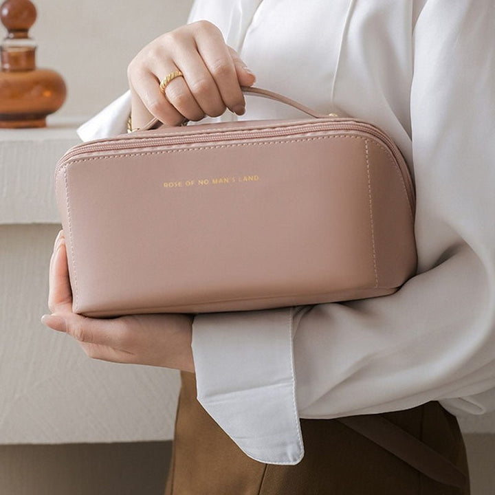 Chic women's travel makeup organizer bag, spacious portable beauty case for cosmetic essentials.