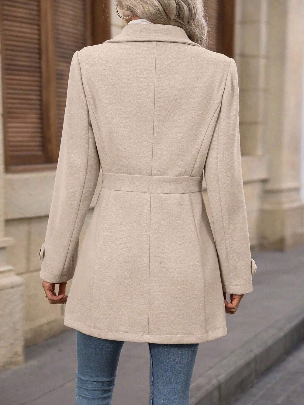 Stylish long trench coat for women, featuring an adjustable belt and classic notch collar.